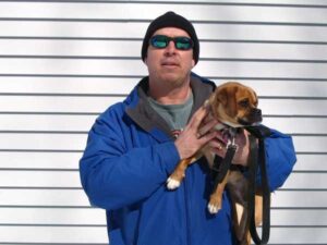 Springfield dog trainer holding dog in his hands